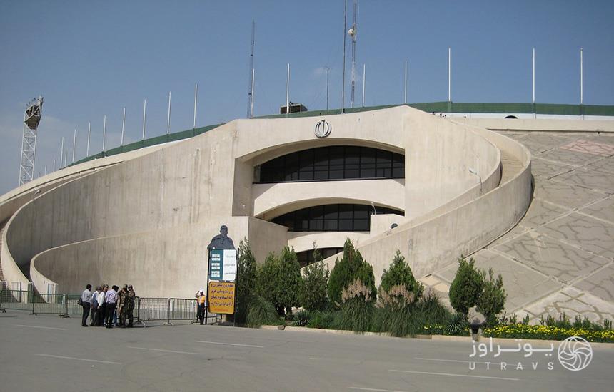 مجموعه ورزشی آزادی در تهران؛ ساختمانی با نمای بتونی که ورودی منحنی‌شکل دارد. 